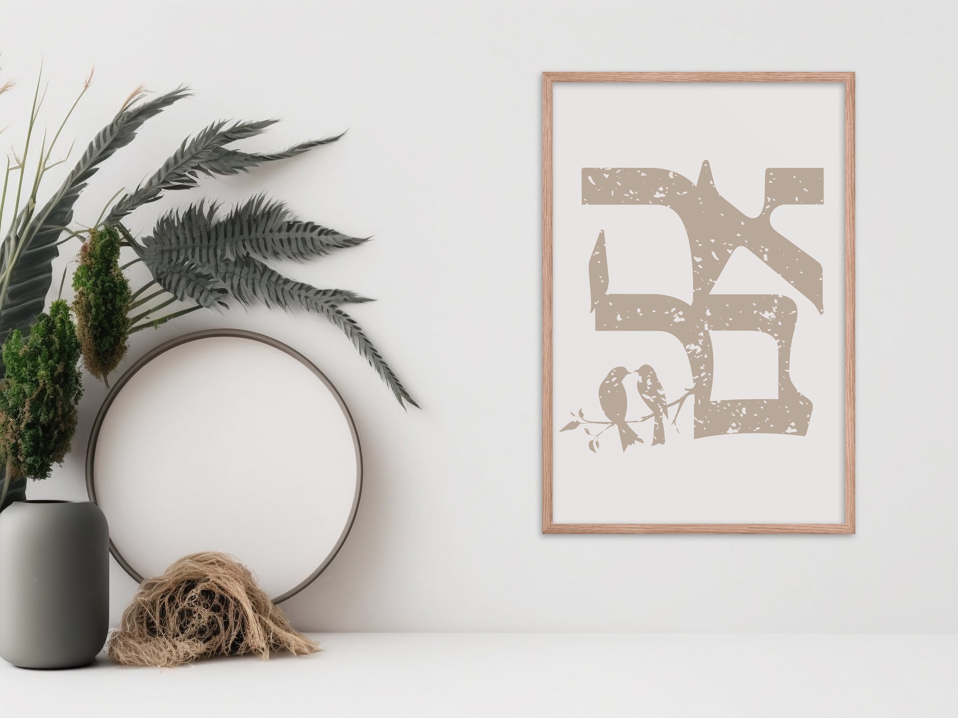 Framed wall art featuring the Hebrew word 'אהבה' (Love) in a vintage distressed style, with two birds on a branch, displayed next to a vase and dried botanical decor.